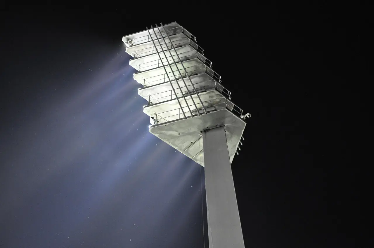Stadionlygte set nedefra mod mørk nattehimmel